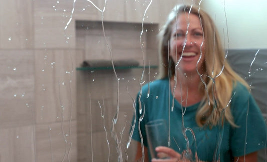 Demonstrating how a shower door water repellent coating like EnduroShield protects glass from water and soap build-up.