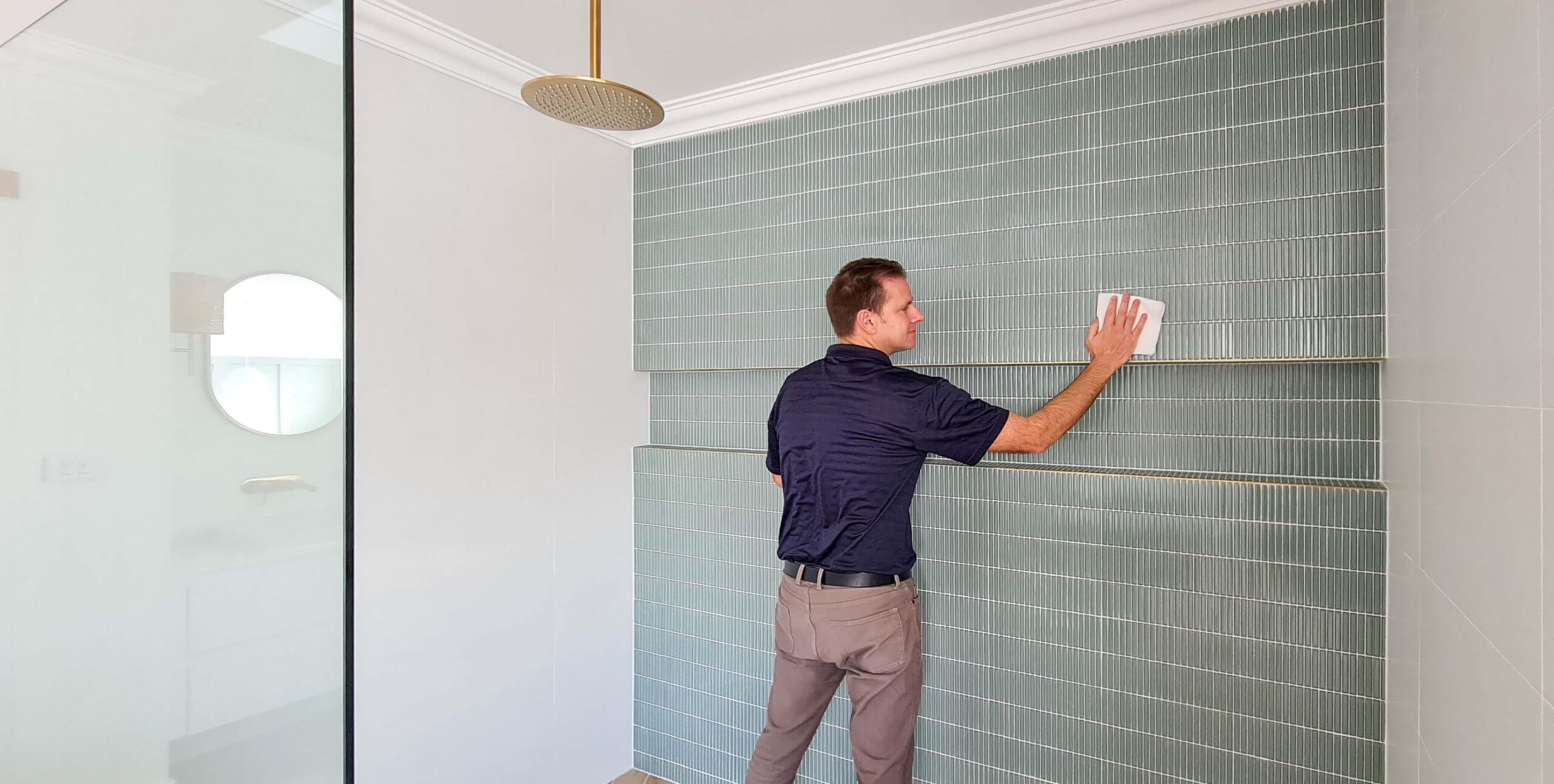man applying enduroshield to green kit kat tiles